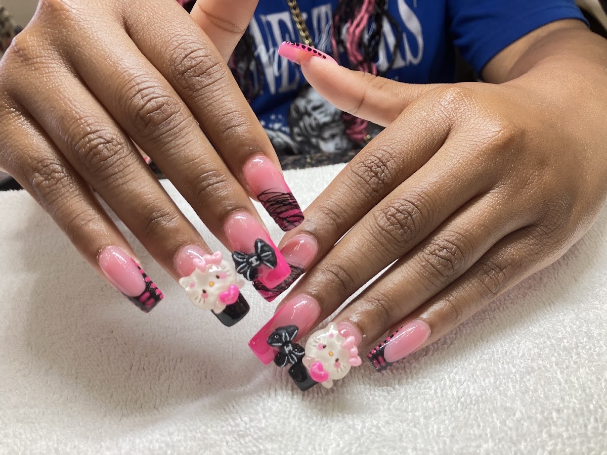Playful pink 3D nail art with bows and charms