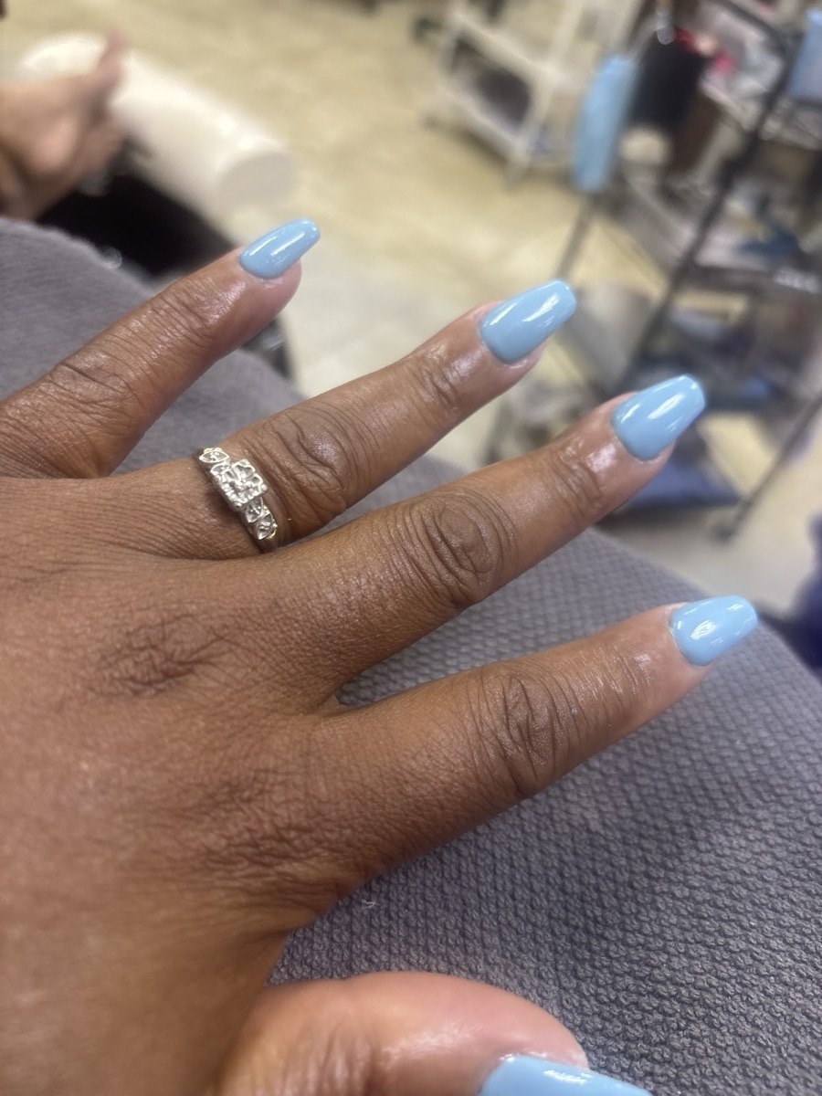 Soft blue gel manicure photographed inside the Nails Spa salon